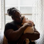 O'Laysha Davis holds her 3-month-old daughter, Journee’ Divine Stokes, in her arms at her home.