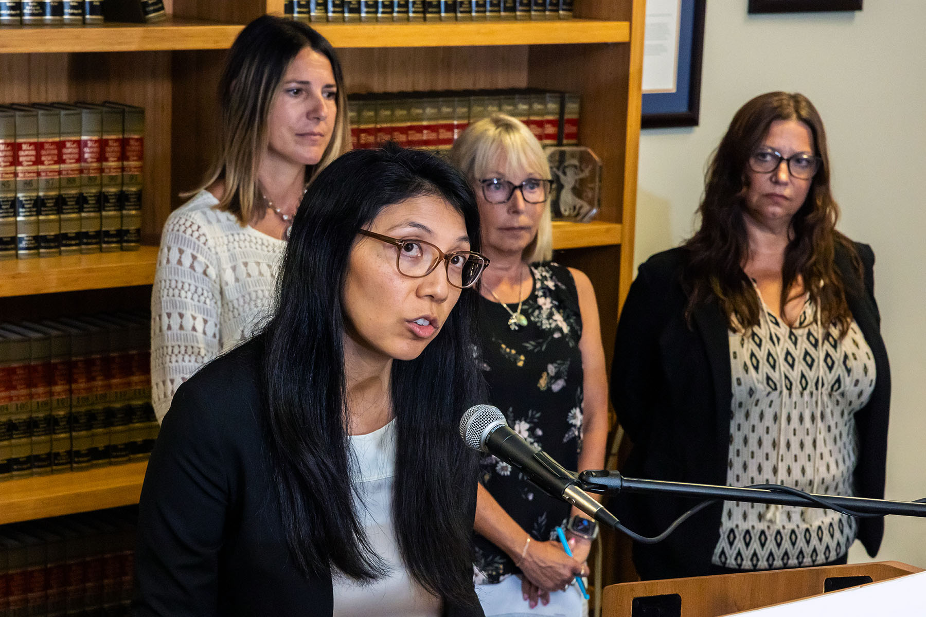 Senior Supervising Attorney Amanda Mangaser Savage makes an announcement about a lawsuit while standing at a podium during a press conference.