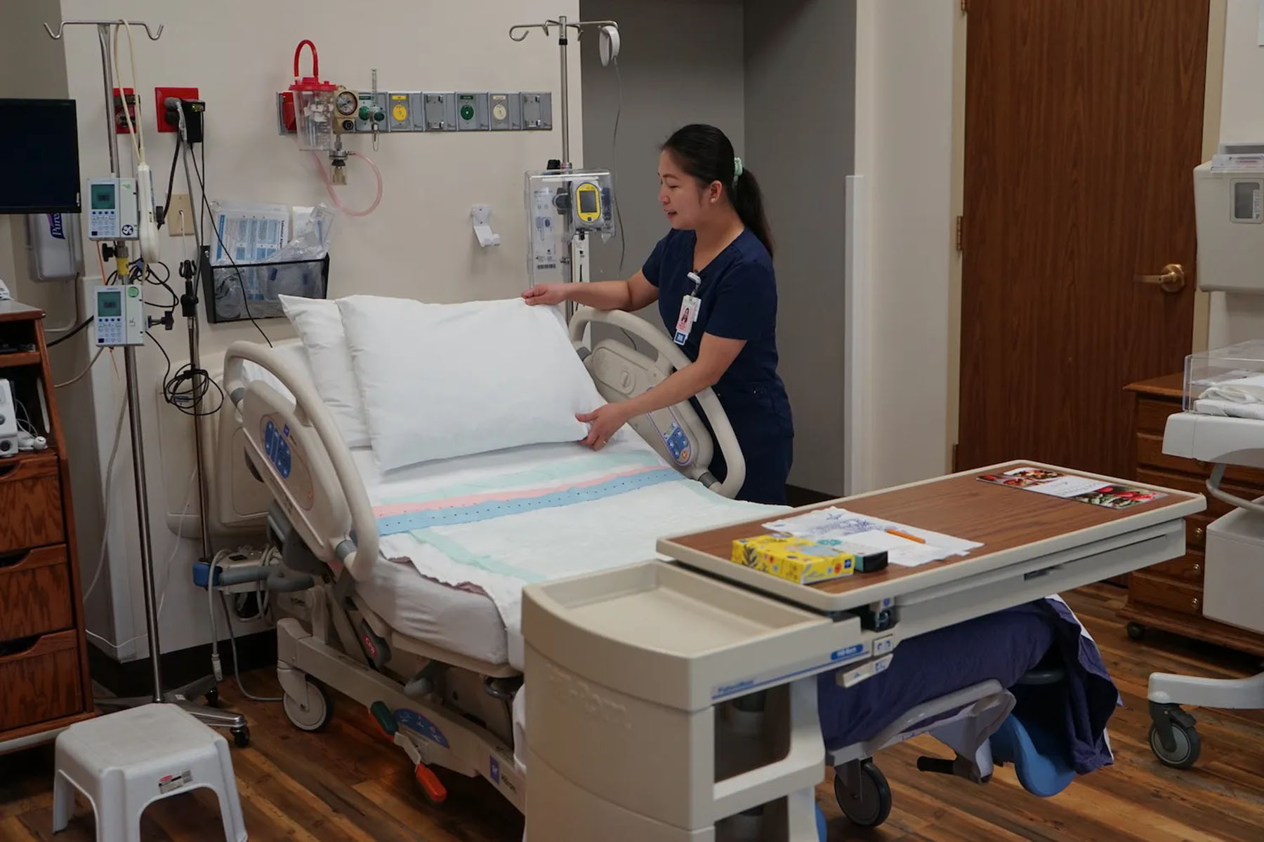 Nurse April Bernal adjusts bedding in a labor suite in SageWest’s Lander hospital.
