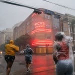 A group of people cross an intersection during Hurricane Ida in New Orleans, Louisiana in August 2021.