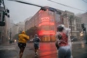 A group of people cross an intersection during Hurricane Ida in New Orleans, Louisiana in August 2021.