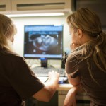 Two nurses discuss ultra sound results.