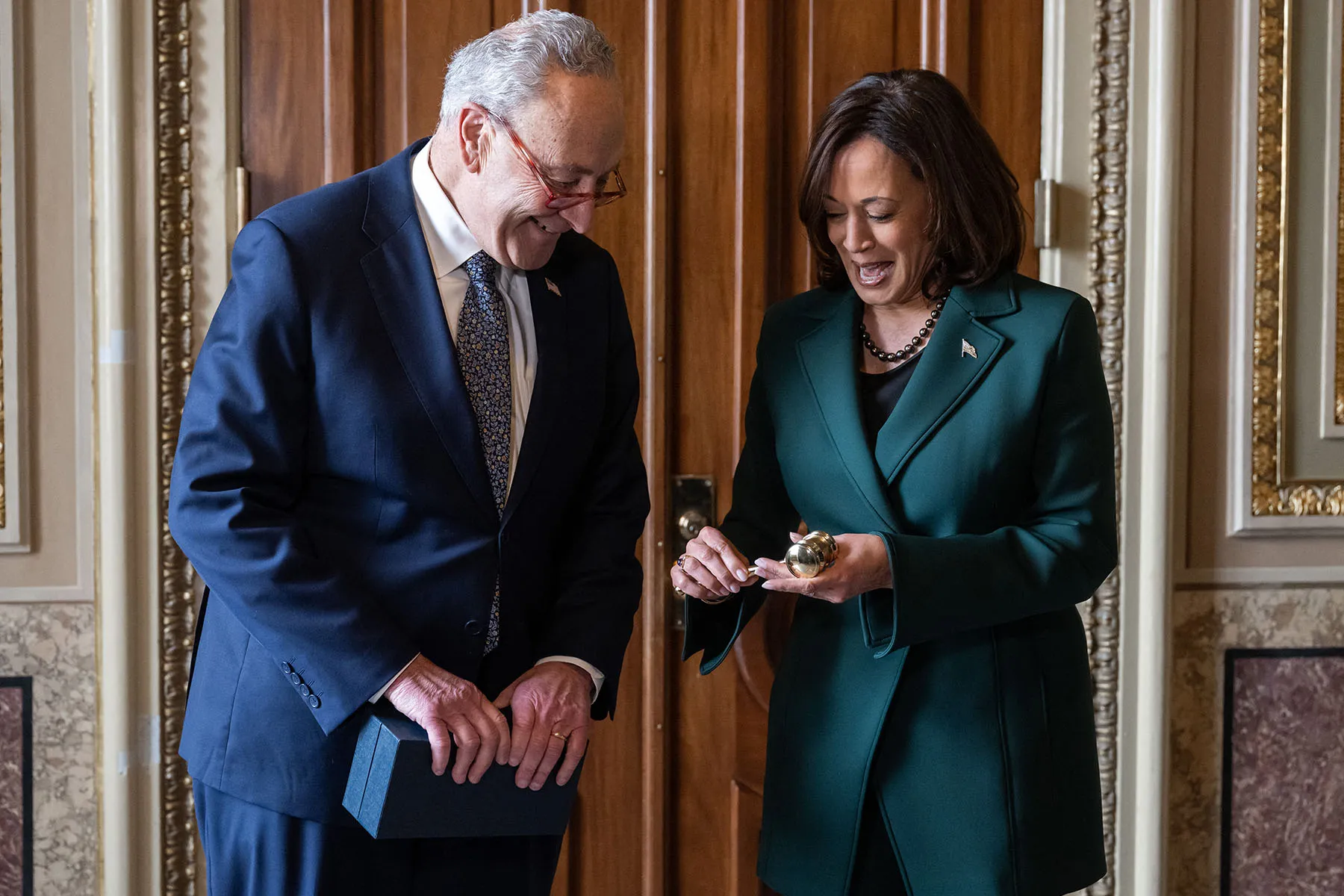 Senate Majority Leader Chuck Schumer presents Vice President Kamala Harris with a "golden gavel."