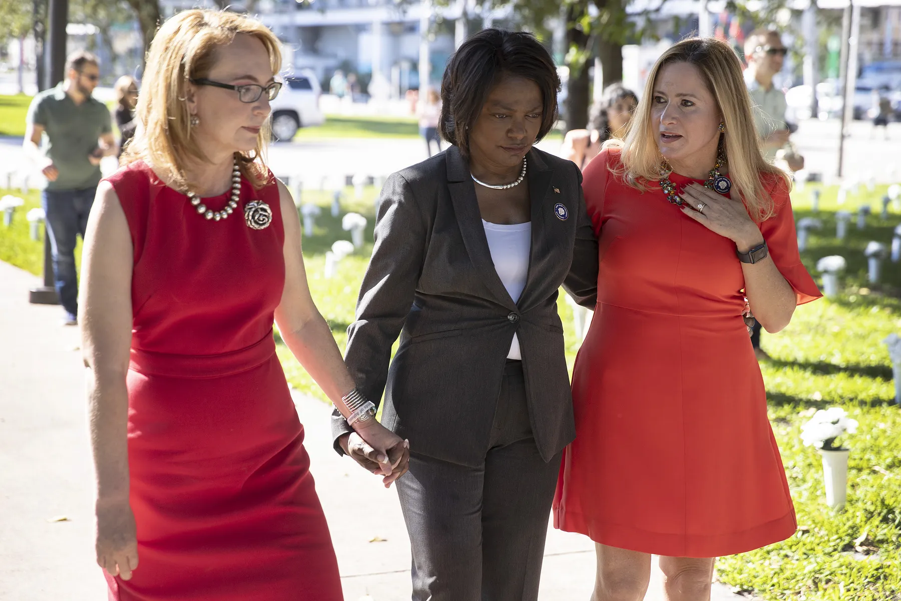 Three women walk outside at a gun violence memorial at Bayfront Park in Miami.