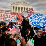 Abortion-rights supporters stage a counter protest in front of the Supreme Court during the 50th annual March for Life rally.