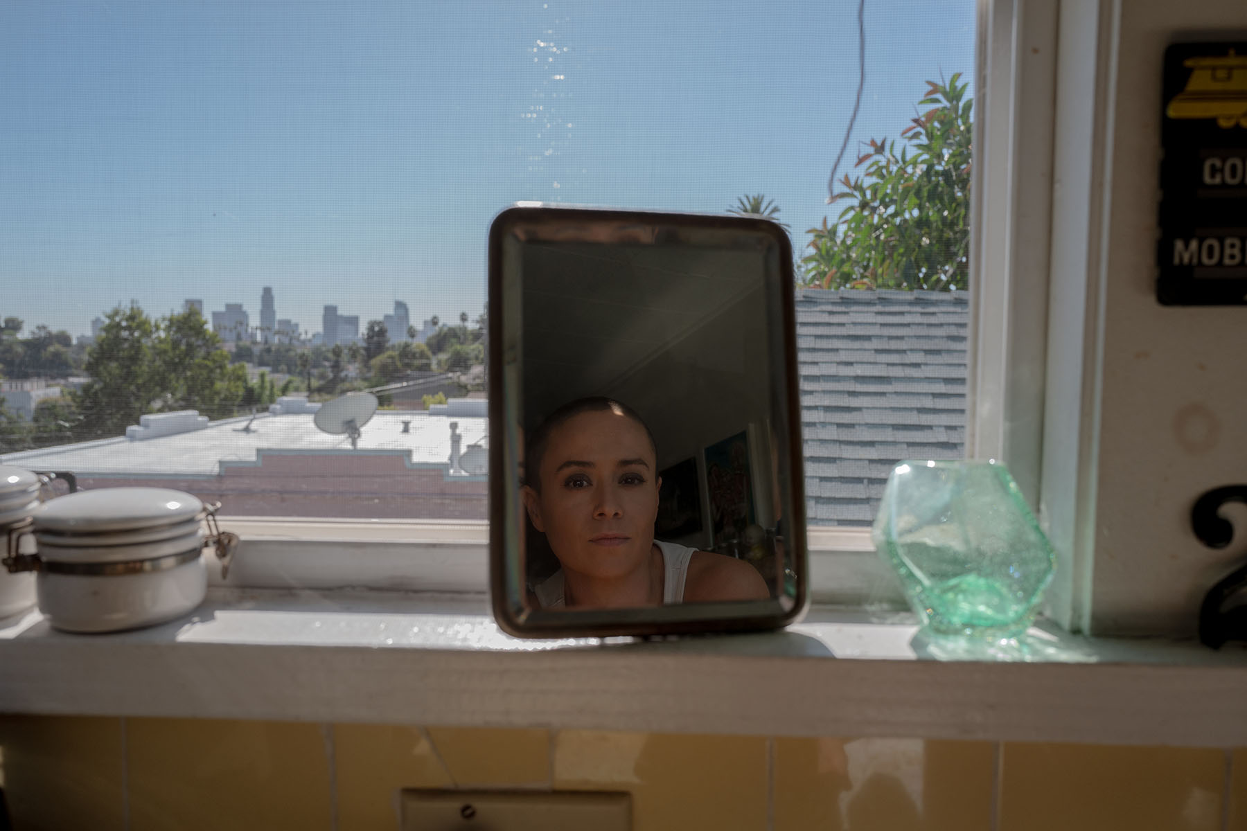 Briana Venskus is seen reflected in a mirror at her home.