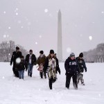 Amidst snow and freezing temperatures, a group of people walk on the Nartional Mall to attend the annual March for Life rally on January 19, 2024 in Washington, D.C.