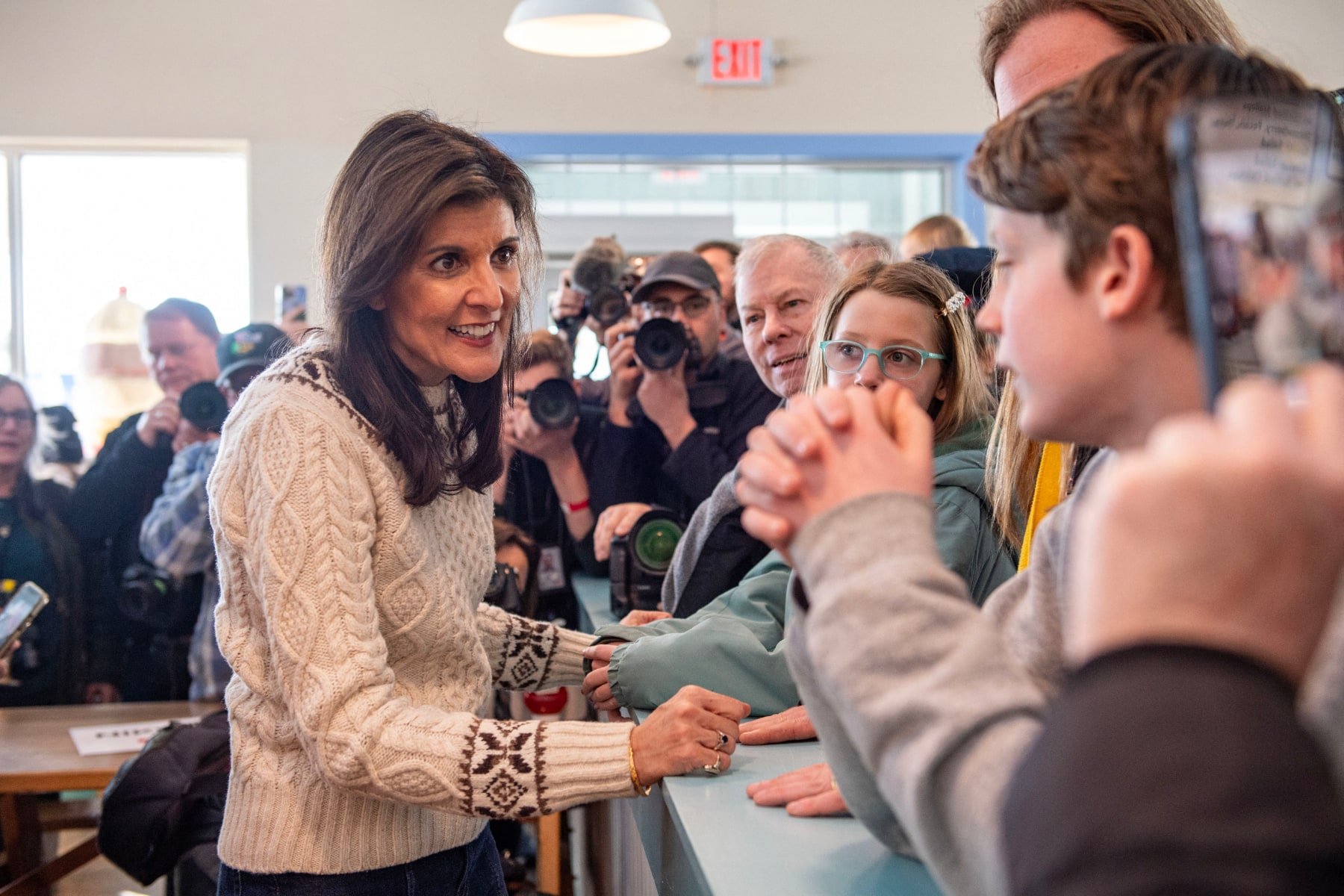Nikki Haley talks to a crowd of voters inside in New Hampshire