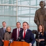 Rep. Matt Gress and other legislators hold a press conference in front of a statue of Justice Sandra Day O’Connor.