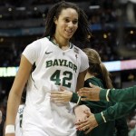 Brittney Griner of Baylor University starts to celebrate with her teammates on a basketball court.