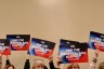 Supporters of a campaign hoping to amend the state constitution to roll back Missouri’s abortion ban lift signs that read 