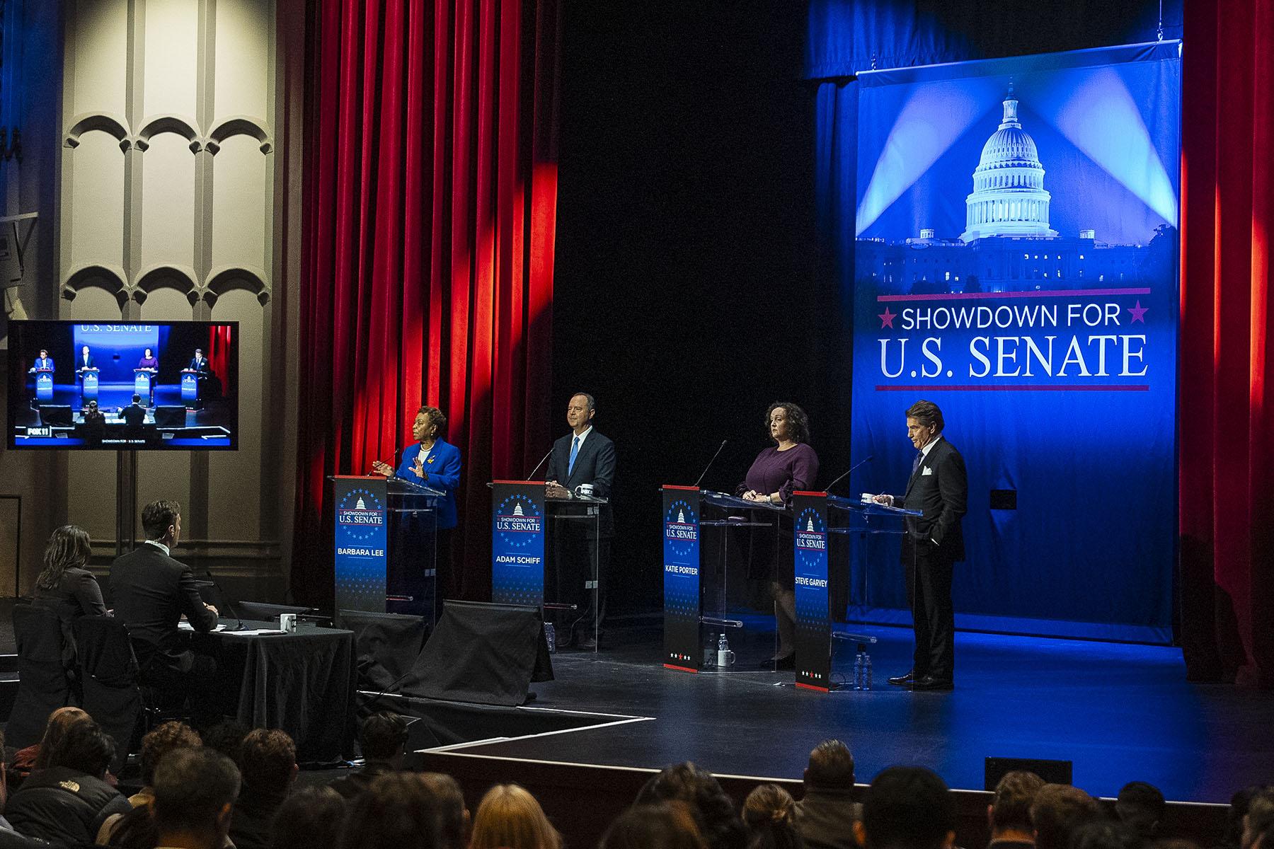 Senate Candidates for California stand on stage during a televised debate.