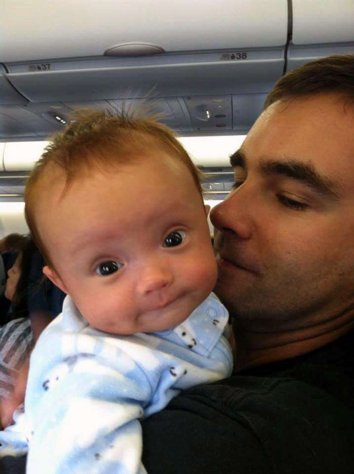 Wiley Muir's father holds his baby on an airplane.