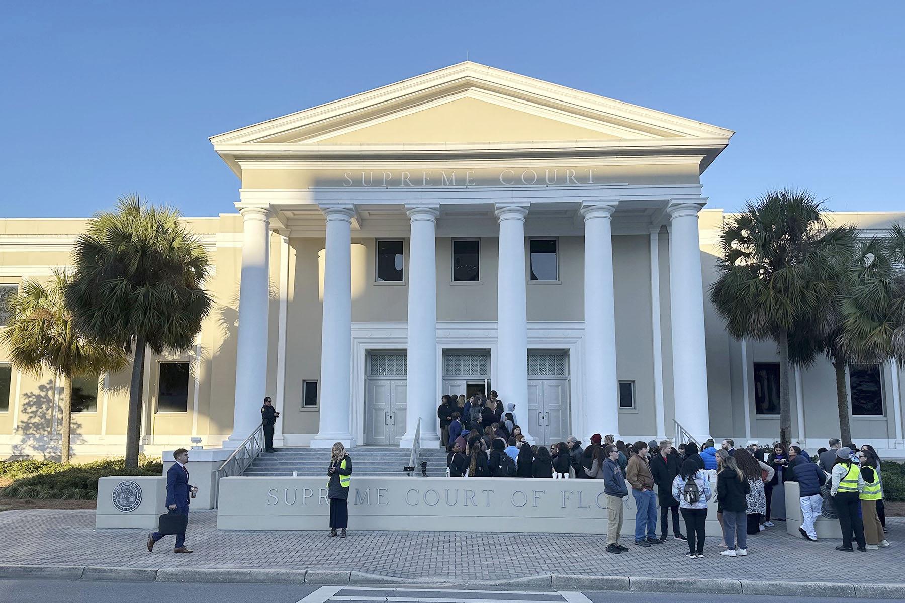 People gather outside the Florida Supreme Court, where justices will hear arguments on a proposed ballot issue regarding abortion.