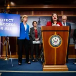 Senator Tammy Duckworth speaks during a press conference with other Senate Democrats.