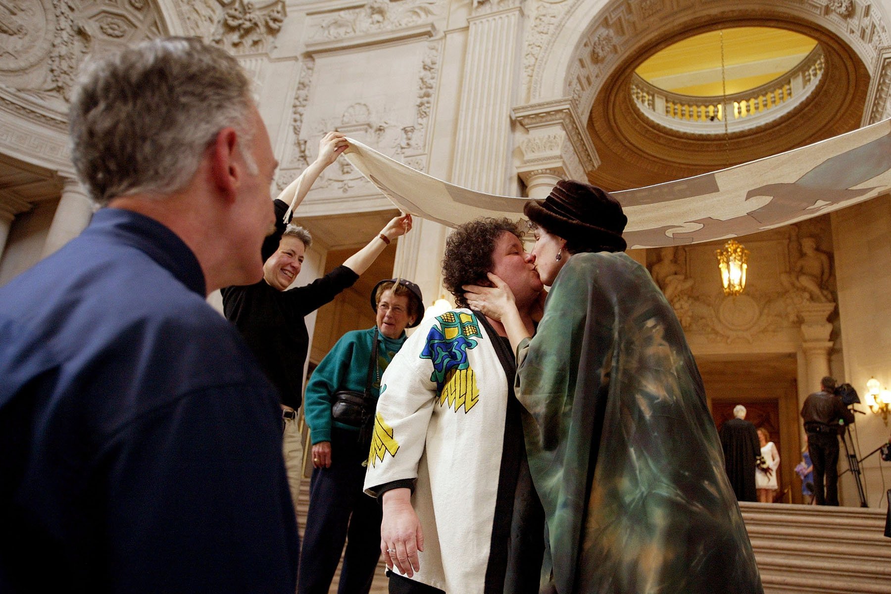 A lesbian couple kisses after they were married in the rotunda of San Francisco City Hall.