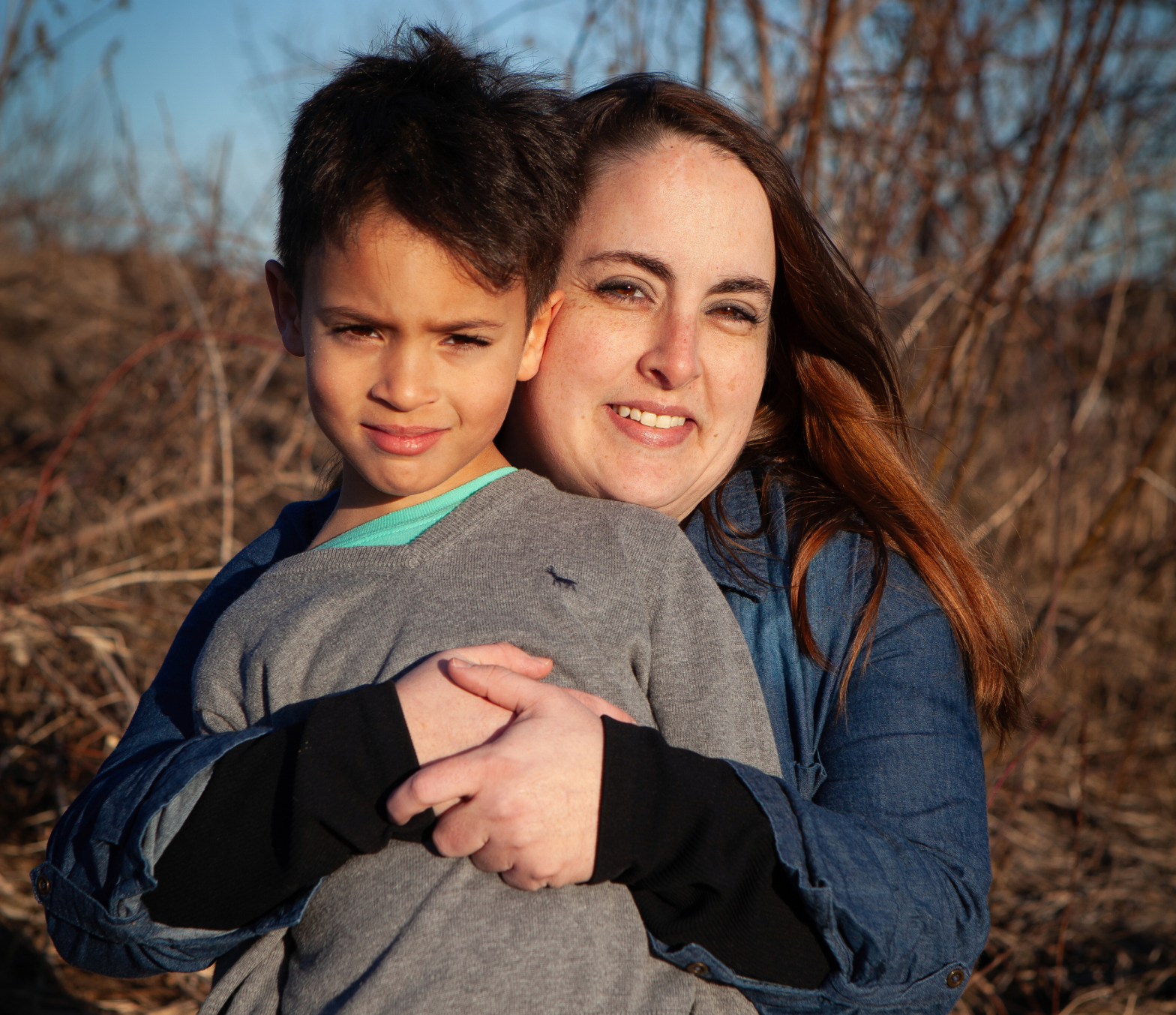 Portrait of Emily Schmit holding her son.