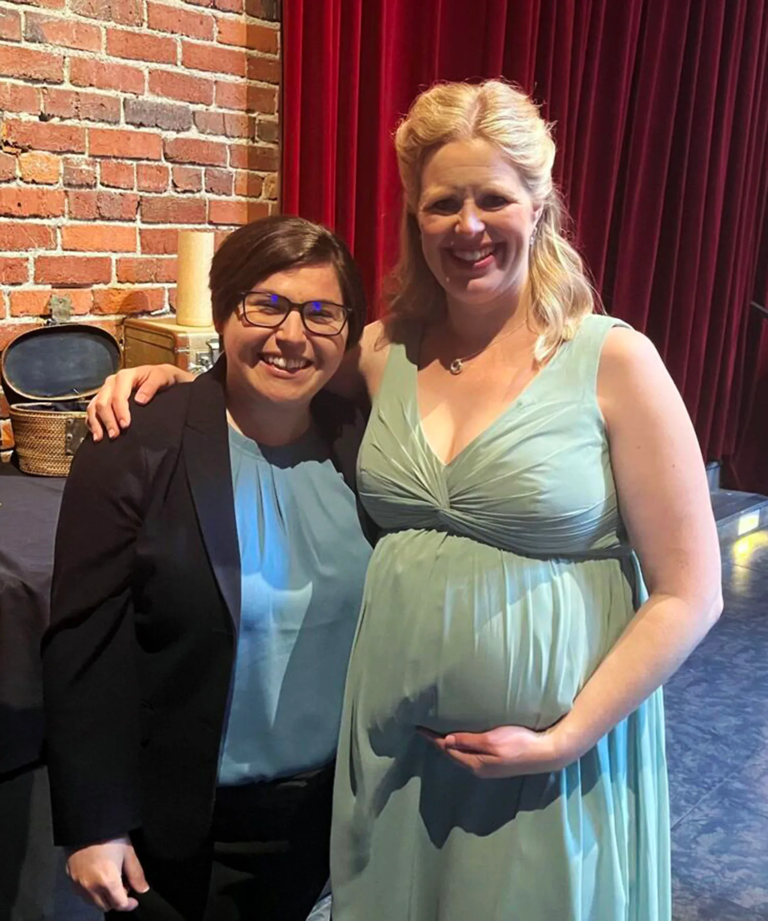 Rebecca Bauer, left, and her wife, Elizabeth Bauer, who is due to give birth in April, pose for a photo together