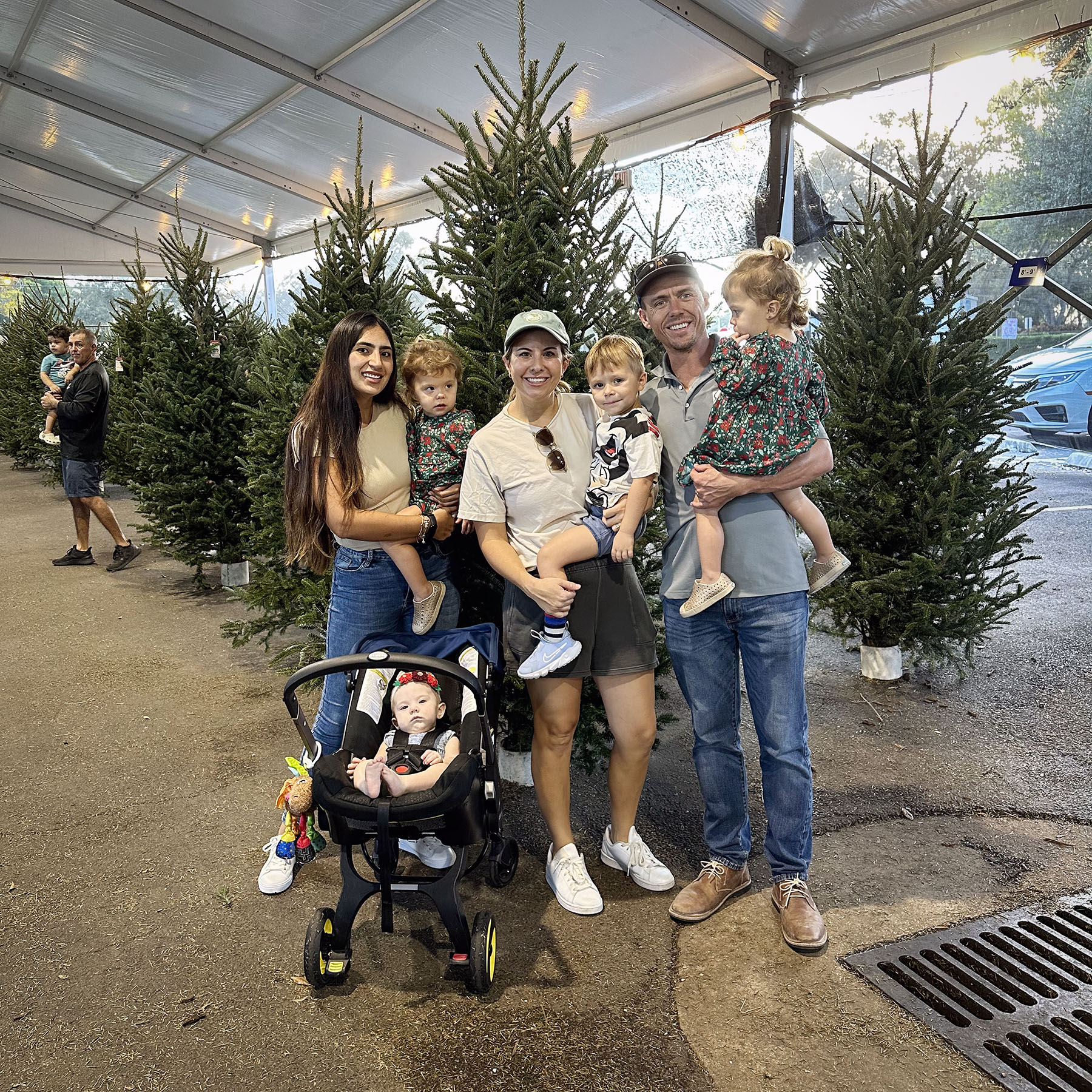 The Thee family and their au pair Valentina pose for a photo at a Christmas tree farm.