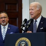 President Joe Biden is joined by Education Secretary Miguel Cardona at the White House lectern.