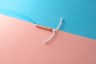 IUD on pink and blue background