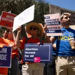 Members of Arizona for Abortion Access protest against the 1864 abortion ban at the Arizona House of Representatives.