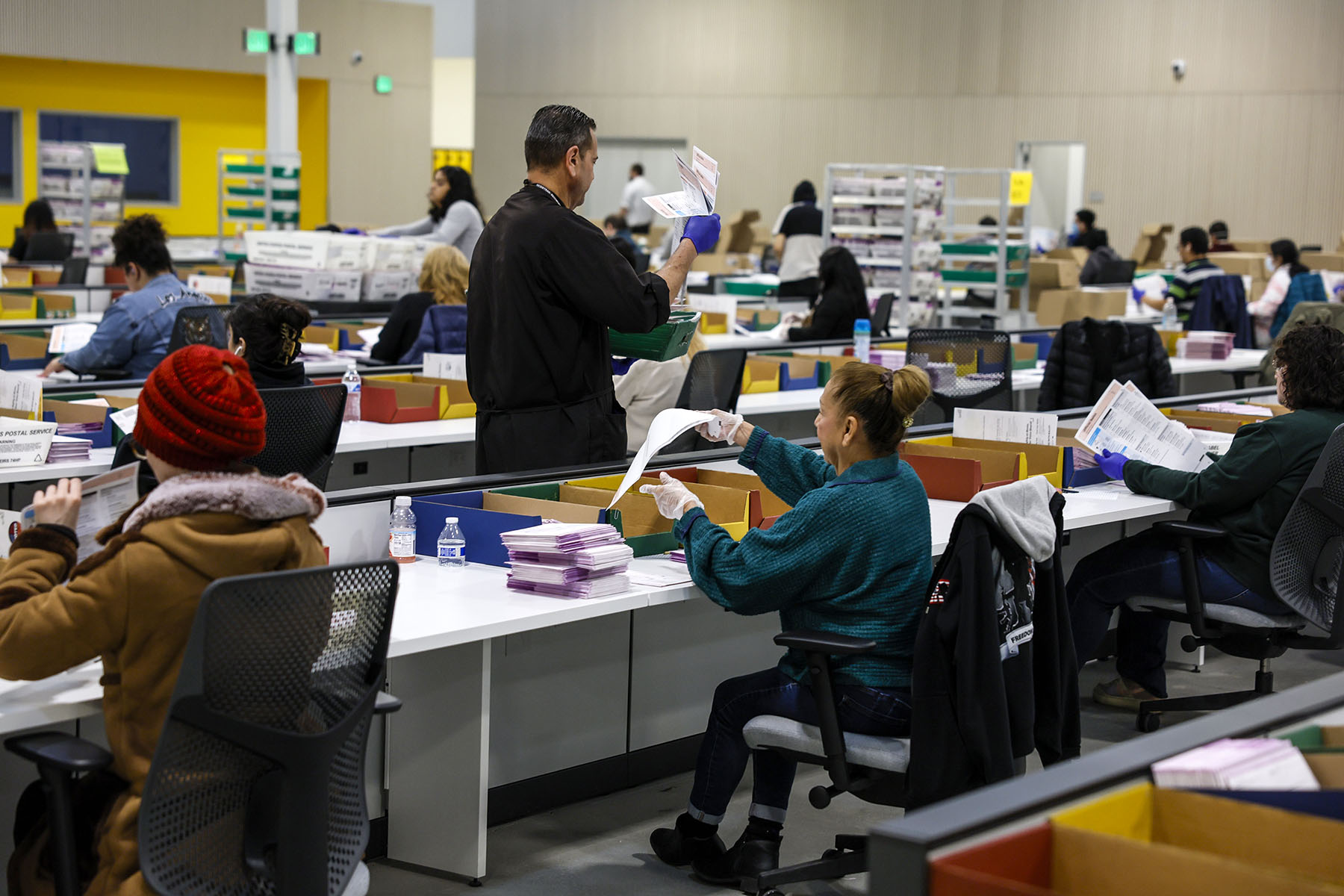 LA County workers process ballots cast in this year's primary election at the LA County Ballot Processing Center.
