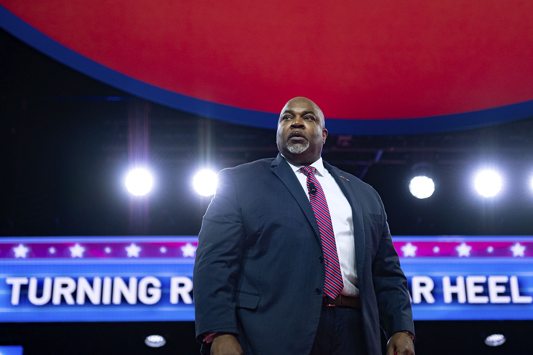 Mark Robinson stands on stage at CPAC.