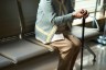 Senior woman sitting with cane.