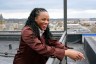 Rep. Summer Lee laughs as she stands for a portrait on a rooftop overlooking the East Liberty neighborhood of Pittsburgh.