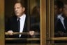 Harvey Weinstein exits through a door after a court arraignment in New York City.
