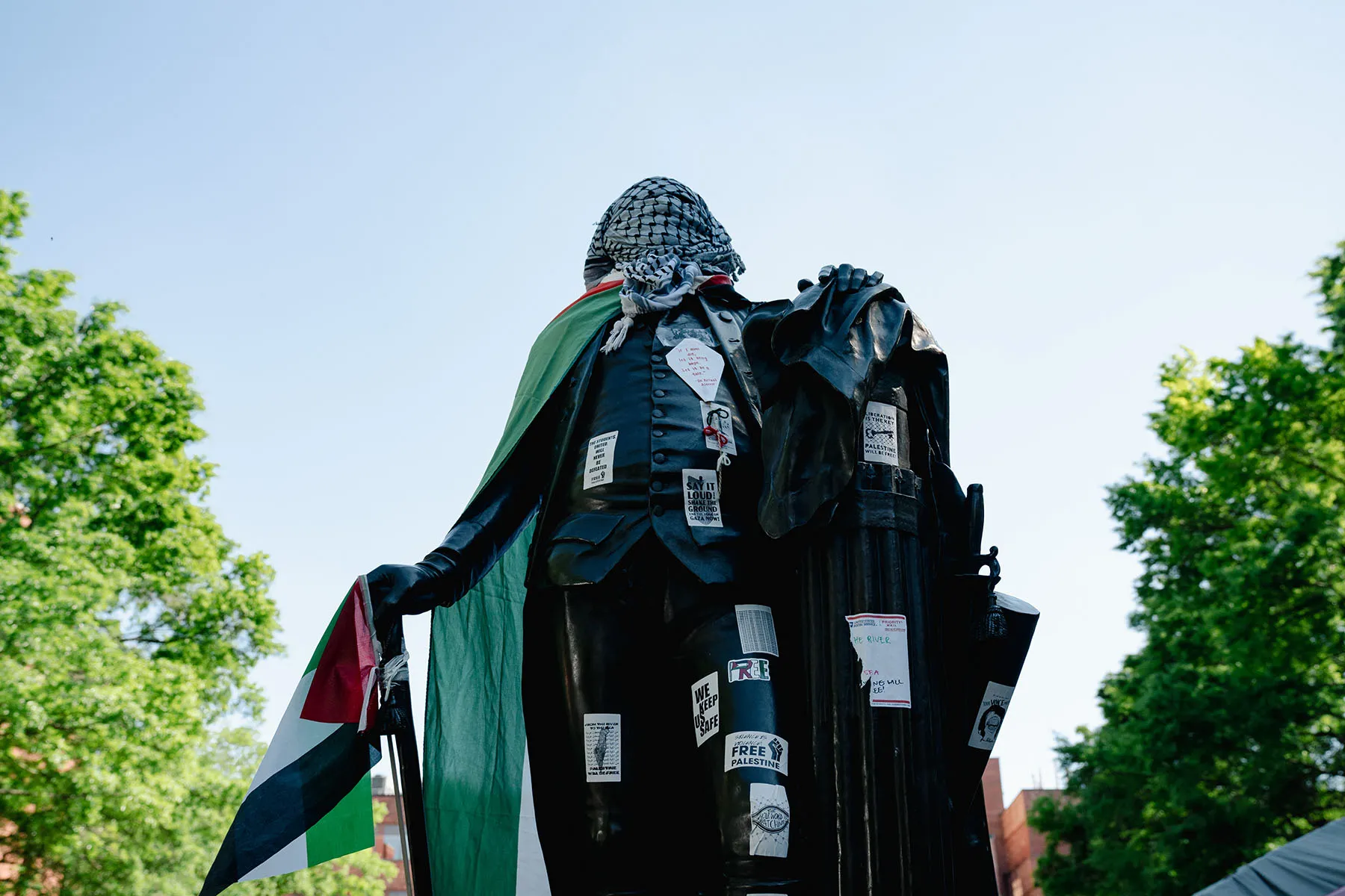 A sculpture of George Washington at University Yard is seen wearing a keffiyeh and a Palestinian flag on the George Washington University campus.