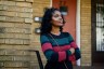 Diane Lewis stands for a portrait on the steps of the apartment building where she grew up in the Upper Albany area of Hartford, Connecticut.