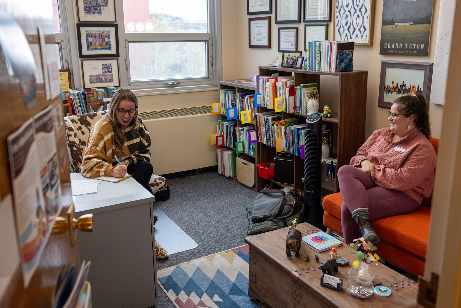 A recent graduate sits for a meeting with her professor at the University of Montana.