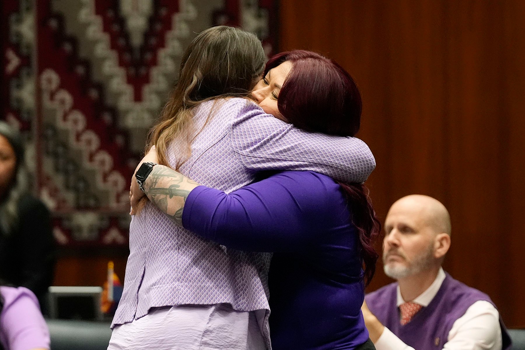 Arizona Rep. Stephanie Stahl Hamilton (left) gets a hug from Sen. Anna Hernandez.