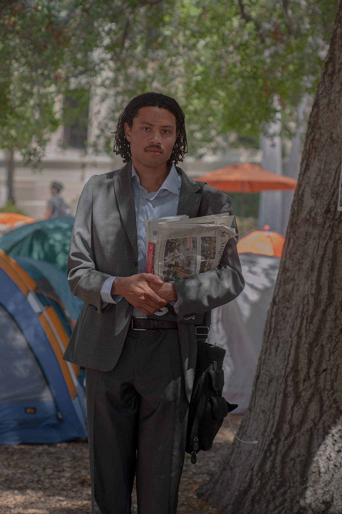 Matthew Vickers poses for a portrait at the Occidental College encampment.