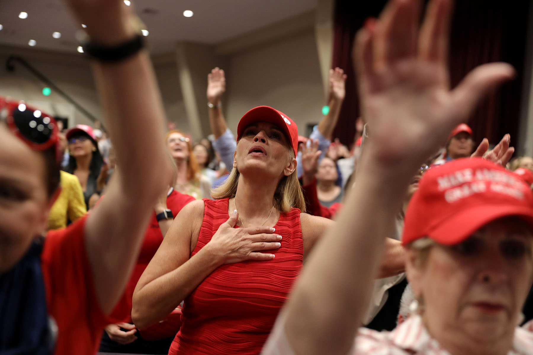 Supporters pray during an 'Evangelicals for Trump' campaign event.