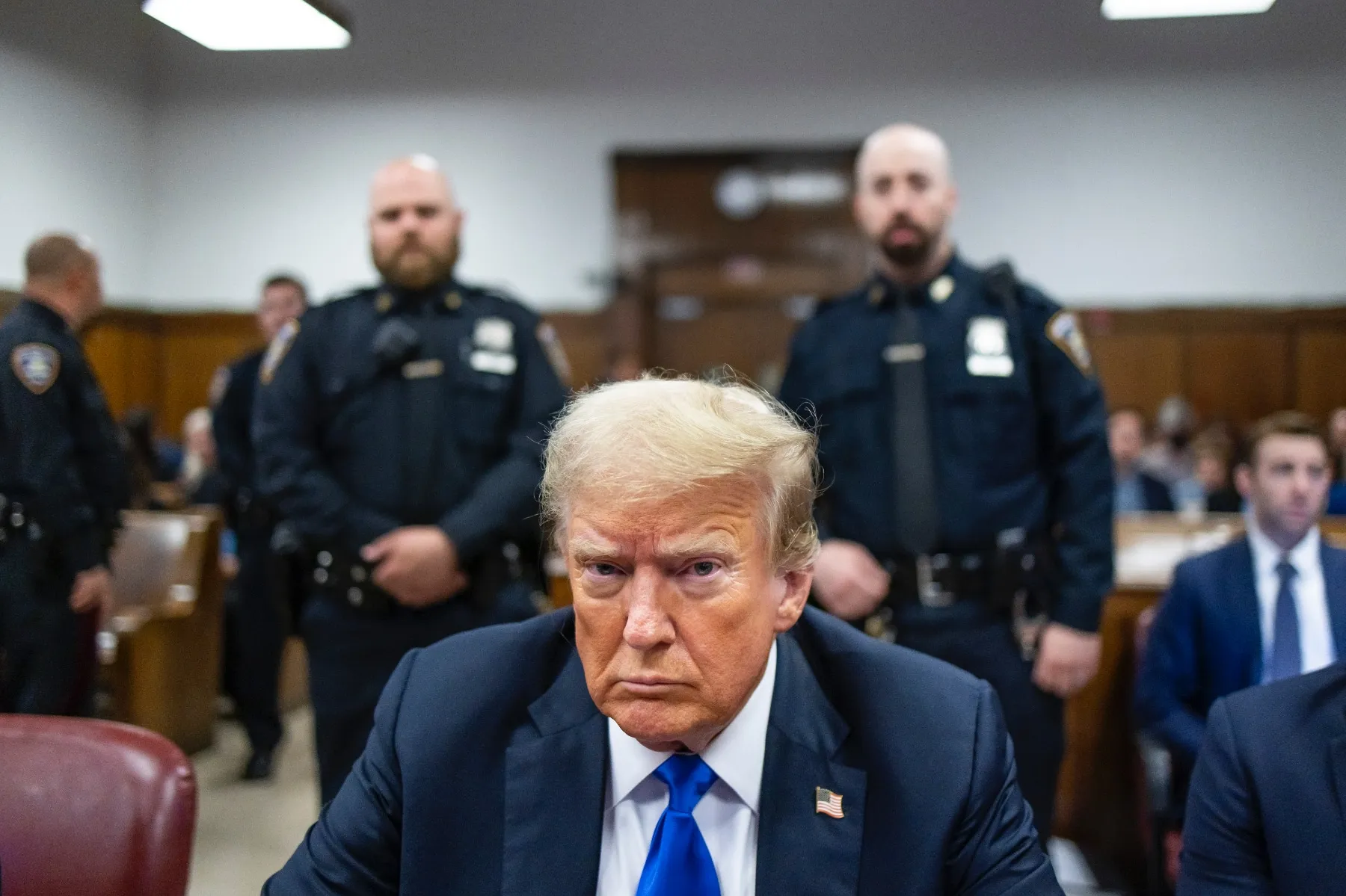 Former President Donald Trump sits at the defendant's table in the courthouse