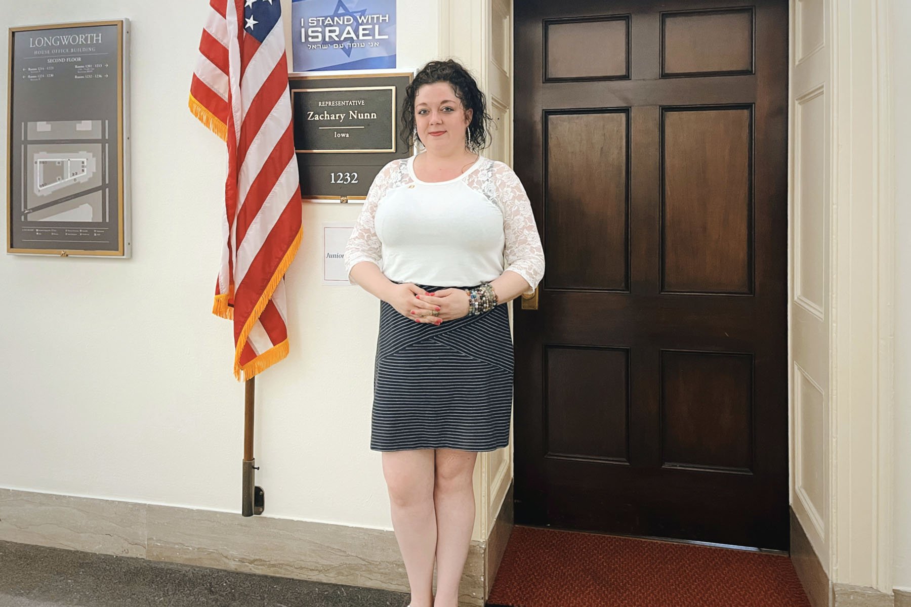 Elizabeth Feldman poses for a portrait in front of the office of Rep. Zach Nunn on Capitol Hill.