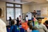 Young children, ages three to five participate in morning warm-up at at child care center.