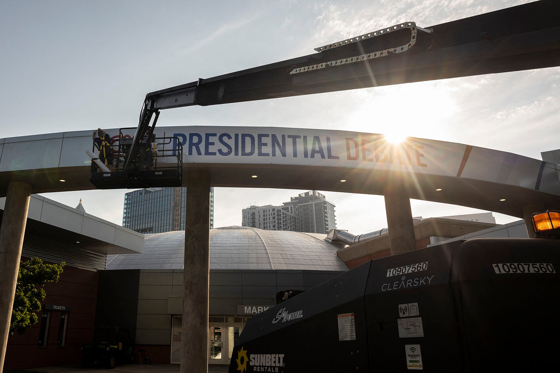 People on a crane place a banner that reads "Presidential Debate" outside of the Georgia Tech Institute of Technology ahead of the first presidential debate in Atlanta, Georgia