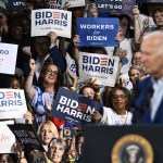 Supporters cheer as President Joe Biden speaks at a campaign rally.