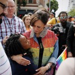 Kamala Harris sported a rainbow colored jacket as she hugs a young supporter before the start of the SF Pride Parade in San Francisco.