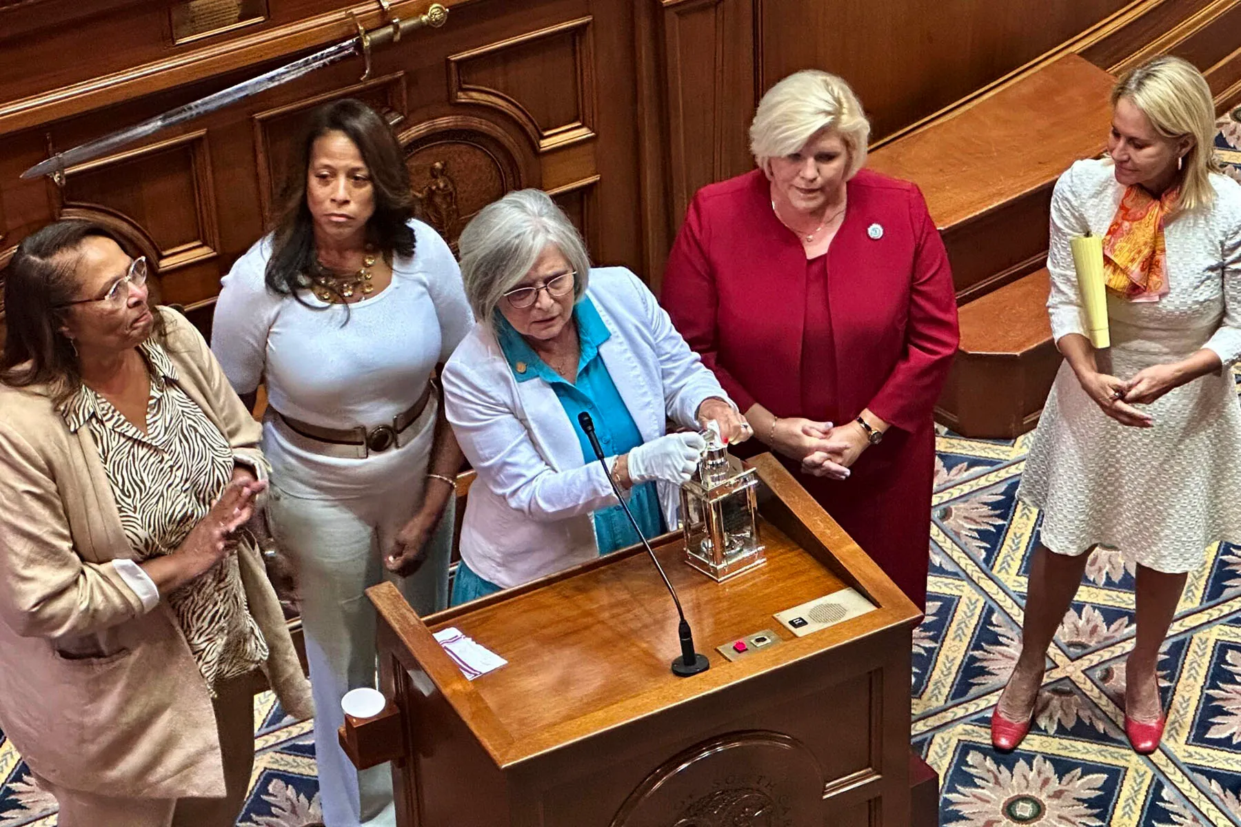 Sen. Katrina Shealy holds up the John F. Kennedy Profile in Courage Award given last fall to the five bipartisan “sister senators” who helped block a near-total abortion ban