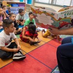 A teacher reads to a kindergarten class.