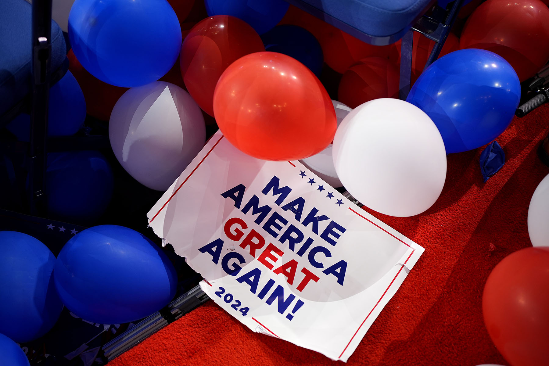 A "Make America Great Again" sign sits among balloons at the end of the fourth day of the Republican National Convention.