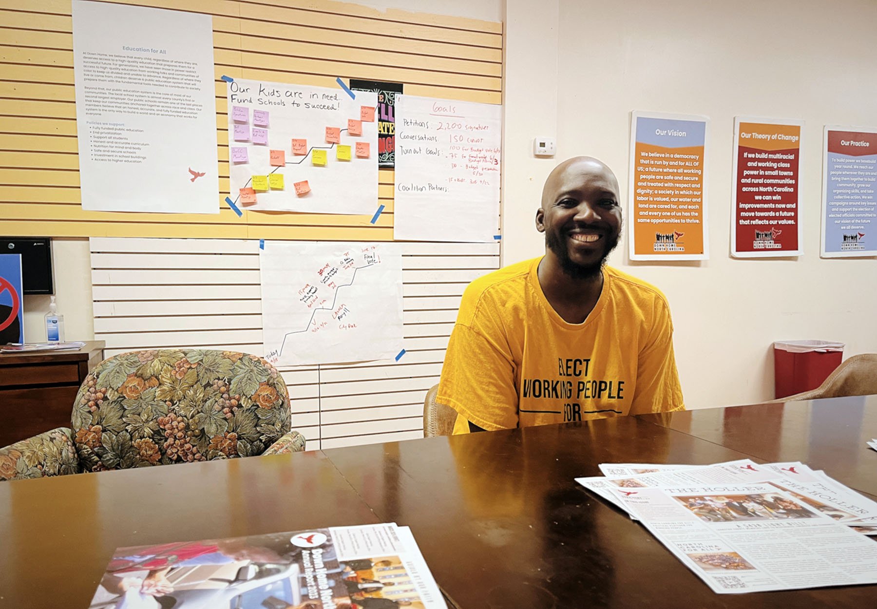 Bryant Crisp, a regional organizer for Down Home NC, poses for a photo at their office.