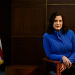 Gretchen Whitmer looks at the camera and smiles as she poses for a portrait.