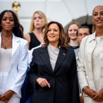 VP Kamala Harris poses with attendees during an NCAA championship teams celebration on the South Lawn of the White House.