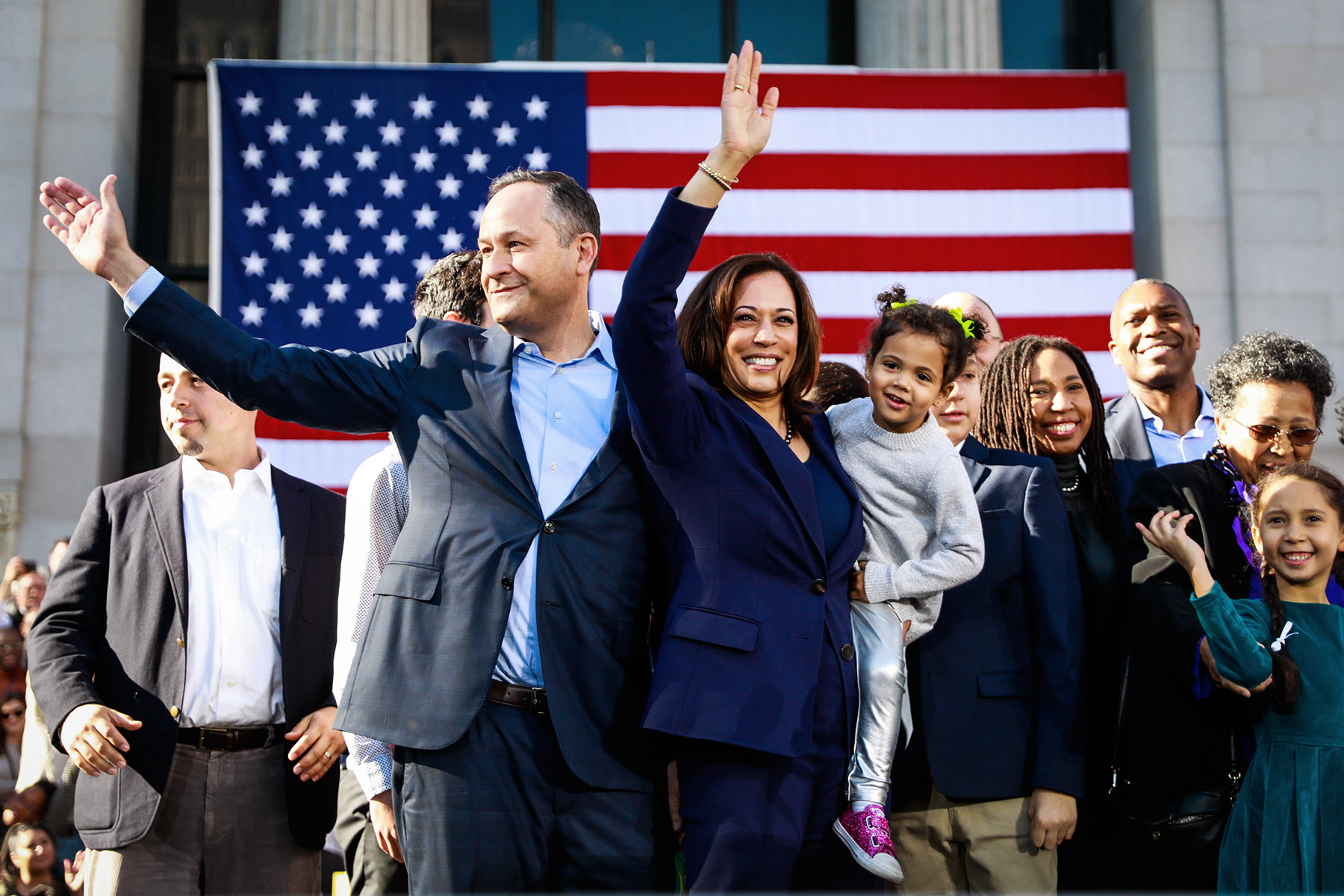 Kamala Harris holds her niece Amara as she and her husband Douglas Emhoff wave to the crowd after her first presidential campaign rally.